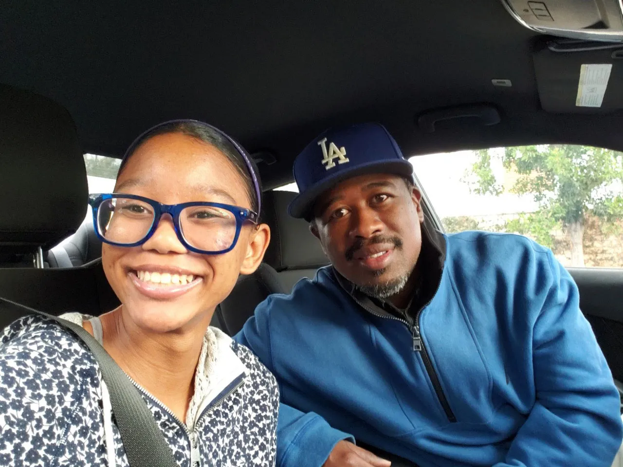 Zara takes a "selfie" with her father Derrick